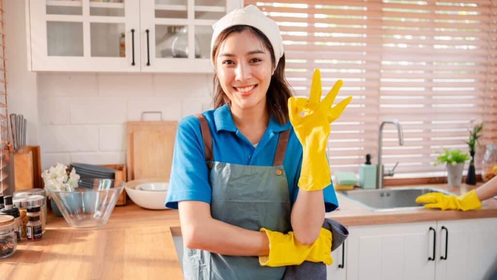 Residential cleaning specialist preparing a sparkling kitchen.